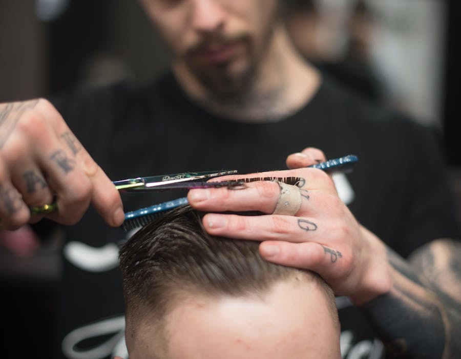 Barbeiro a cortar cabelo com precisão